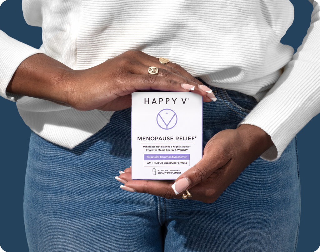 A young woman holding a box of Happy V's Menopause Relief supplements in front of her.