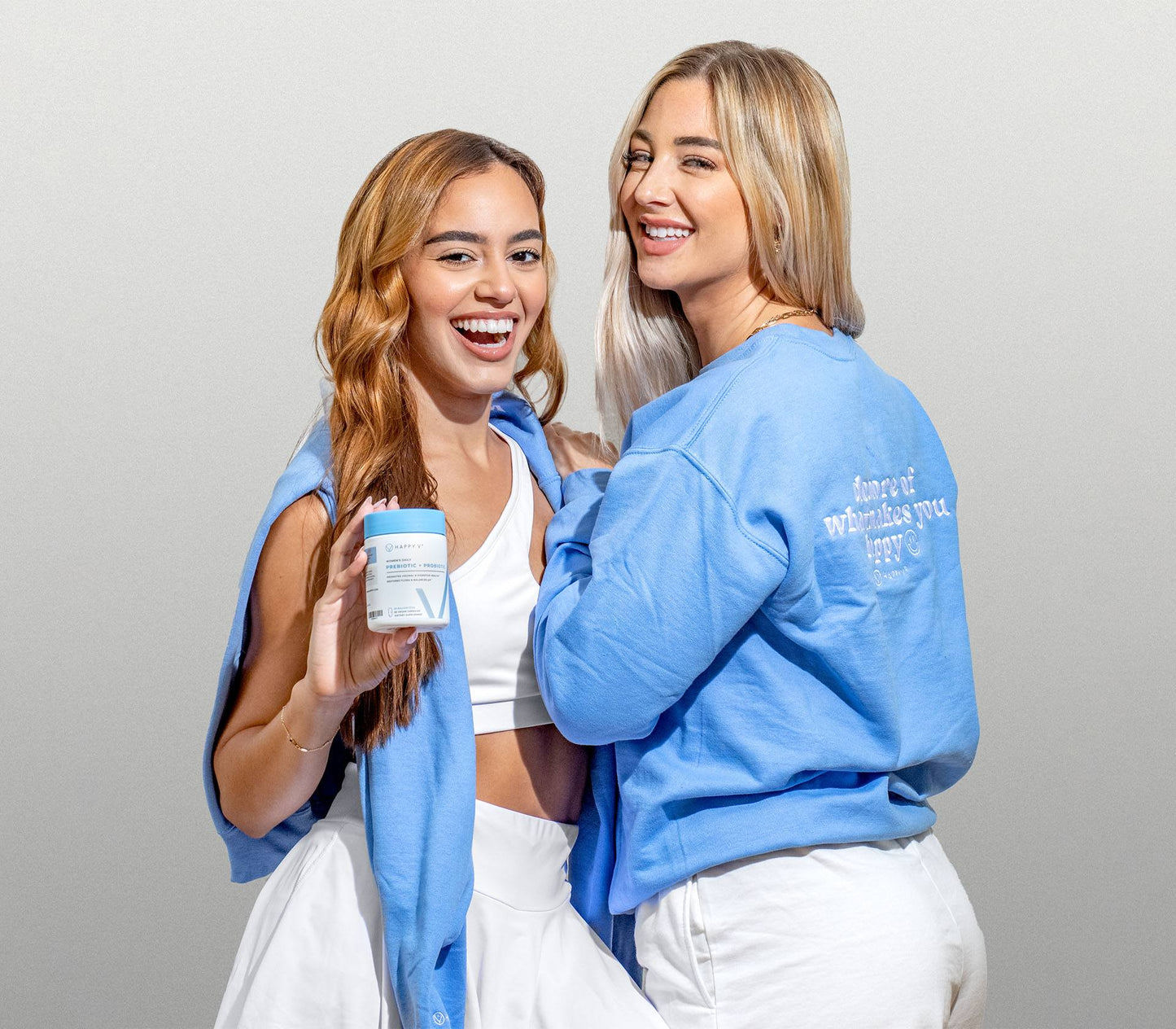 Two women wearing the blue Happy V Crewneck Sweatshirt